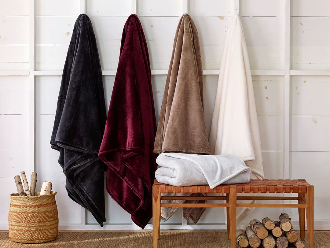 Blankets hanging on a wall.