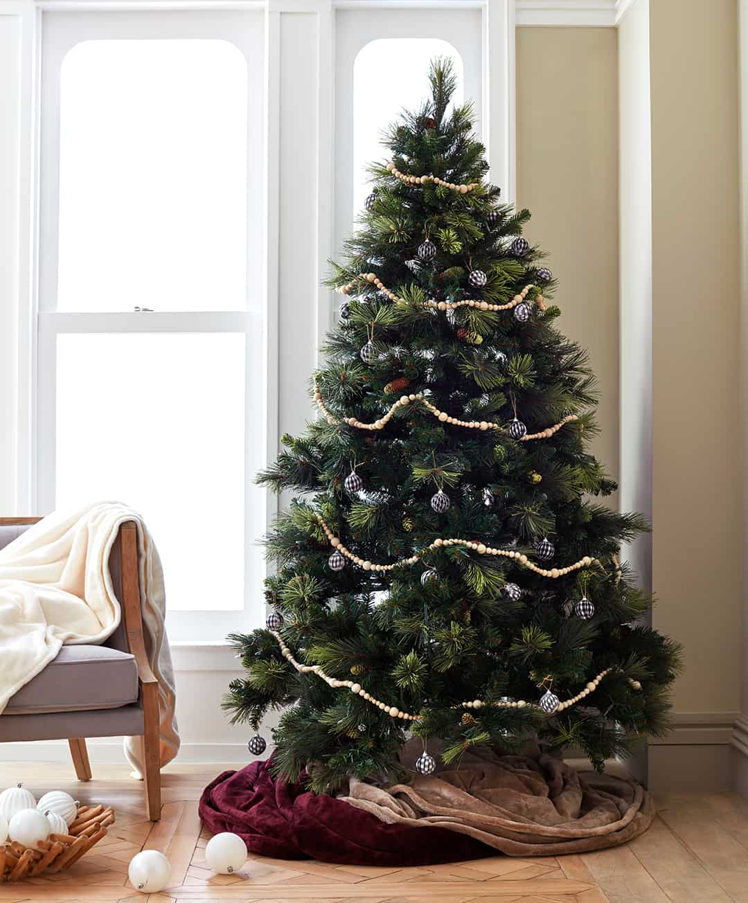Blankets wrapped around base of a Christmas tree.