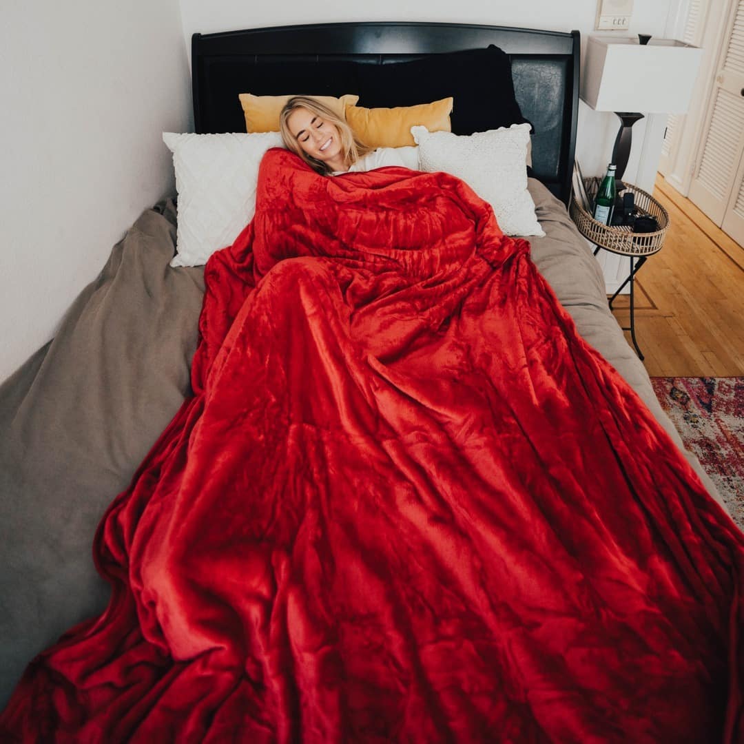 Woman wrapped in a red blanket.