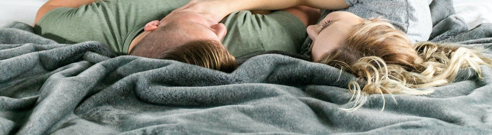 couple laying on a blanket